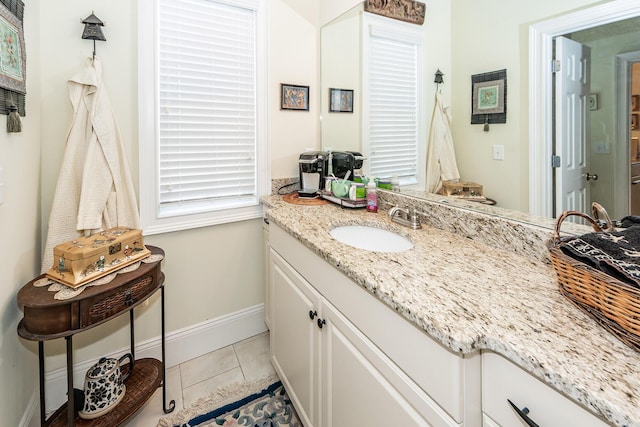bathroom featuring vanity, baseboards, and tile patterned floors