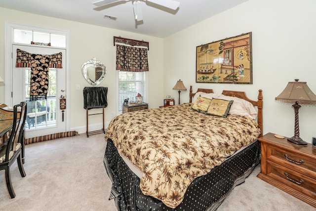 bedroom with light colored carpet, ceiling fan, visible vents, and access to exterior