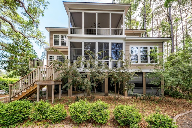 back of house featuring a sunroom and stairway