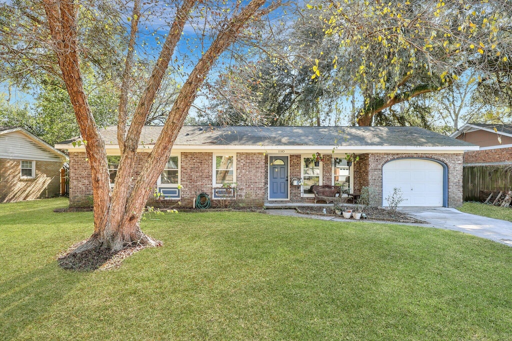 ranch-style home with a front lawn and a garage