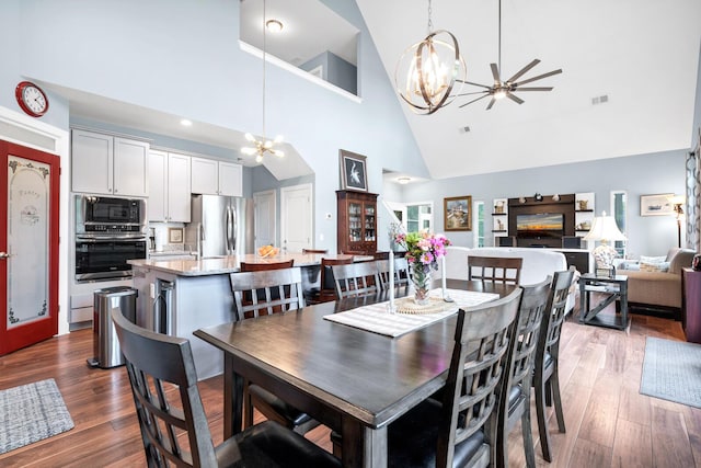 1064 Blackbear Dr, Edisto Island, SC 29438 - dining space featuring a chandelier, high vaulted ceiling, wood finished floors, and ceiling fan