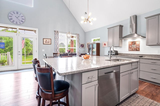 1064 Blackbear Dr, Edisto Island, SC 29438 - kitchen with stainless steel dishwasher, wall chimney exhaust hood, high vaulted ceiling, gray cabinets, and an island with sink