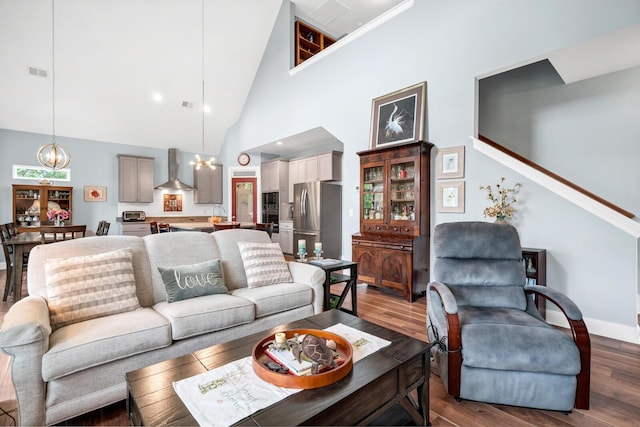 1064 Blackbear Dr, Edisto Island, SC 29438 - living area with a chandelier, wood finished floors, high vaulted ceiling, and stairway