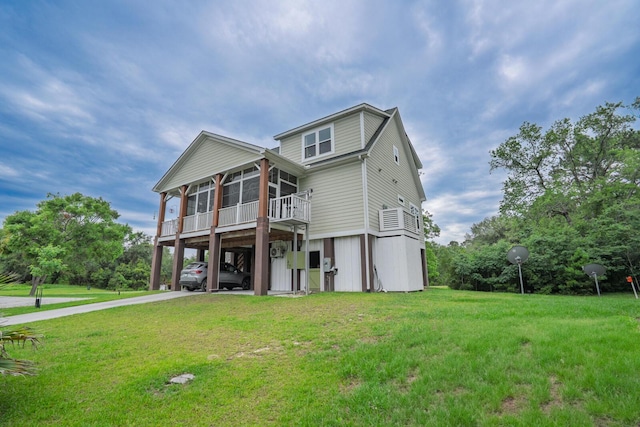 1064 Blackbear Dr, Edisto Island, SC 29438 - view of front of house featuring a carport, a sunroom, concrete driveway, and a front lawn