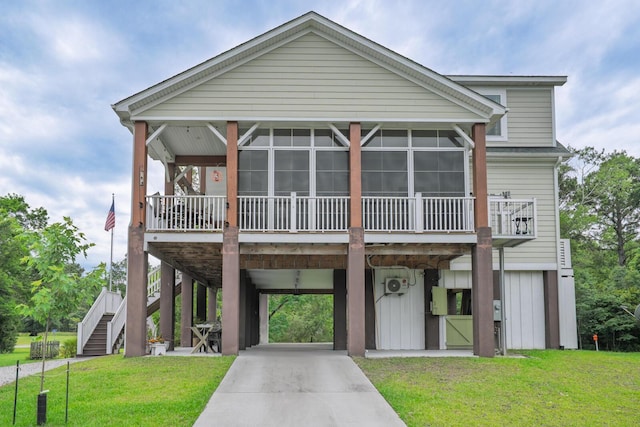 1064 Blackbear Dr, Edisto Island, SC 29438 - coastal home with a carport, a sunroom, driveway, a front lawn, and stairs