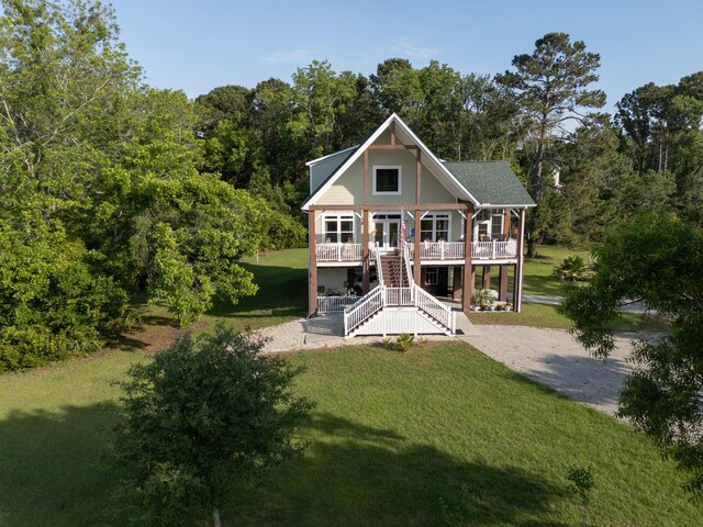 1064 Blackbear Dr, Edisto Island, SC 29438 - view of front facade featuring a front lawn, stairway, and a wooden deck