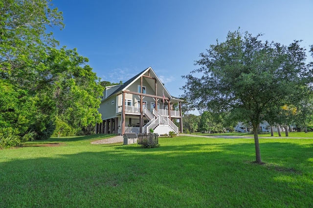 1064 Blackbear Dr, Edisto Island, SC 29438 - back of house with a yard, stairs, and covered porch