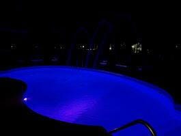 view of pool at night