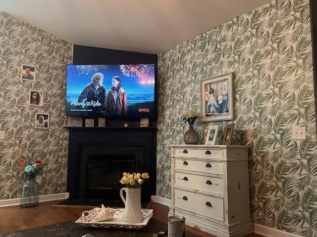 home theater room featuring wood-type flooring