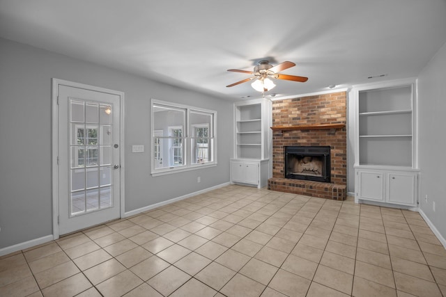 5488 Altamaha Dr, North Charleston, SC 29420 - unfurnished living room featuring built in shelves, ceiling fan, light tile patterned flooring, baseboards, and a brick fireplace