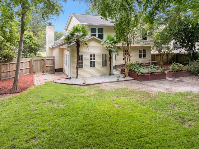 5488 Altamaha Dr, North Charleston, SC 29420 - back of property featuring a garden and a chimney