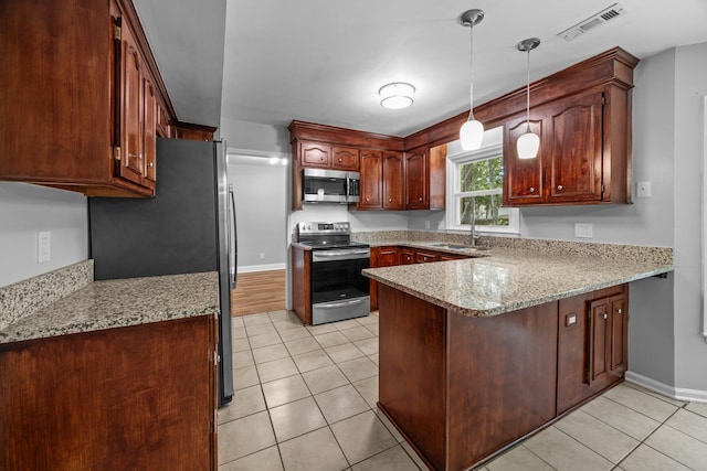 5488 Altamaha Dr, North Charleston, SC 29420 - kitchen featuring stainless steel appliances, a peninsula, a sink, light tile patterned floors, and baseboards