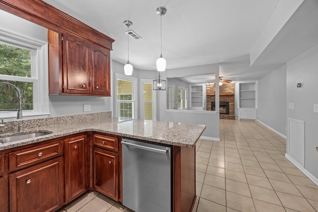 5488 Altamaha Dr, North Charleston, SC 29420 - kitchen featuring dishwasher, a sink, built in features, light tile patterned flooring, and a fireplace