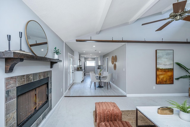 living area with baseboards, lofted ceiling with beams, recessed lighting, ceiling fan, and a tiled fireplace