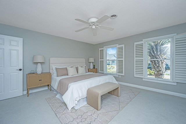 bedroom with multiple windows, visible vents, baseboards, and light carpet