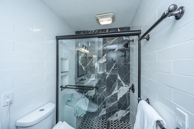 bathroom featuring a shower stall, a textured ceiling, and toilet