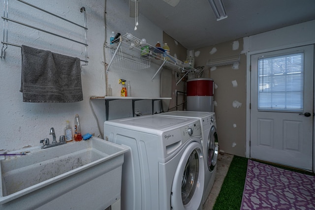 clothes washing area featuring a sink and washing machine and dryer