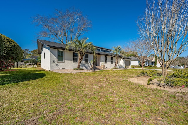 back of house featuring fence, an attached garage, a yard, stucco siding, and crawl space