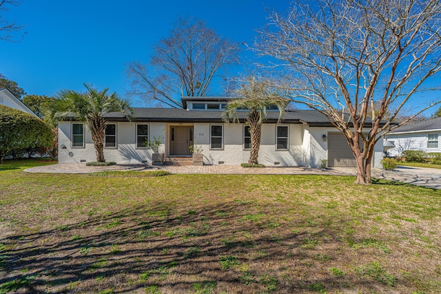 back of house with crawl space, a lawn, an attached garage, and stucco siding