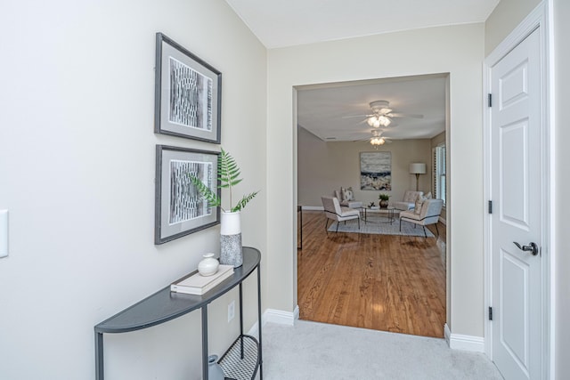 corridor with carpet flooring and baseboards