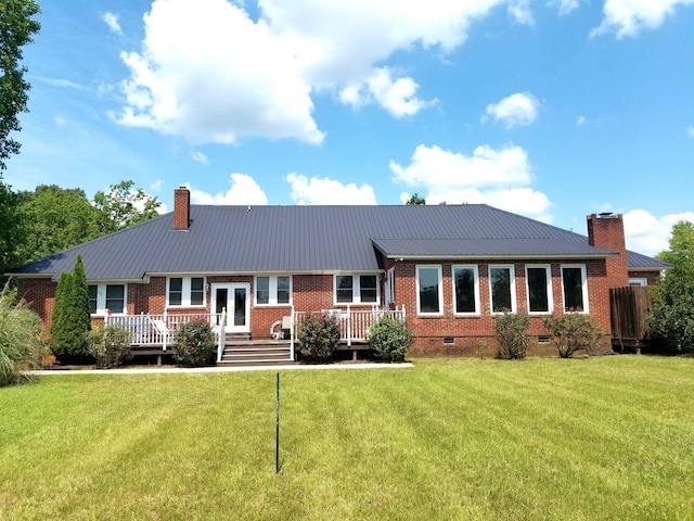 ranch-style home featuring a front yard, french doors, and a deck