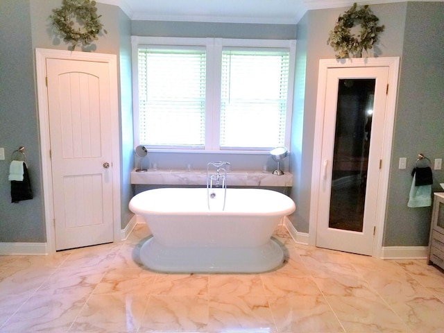 bathroom with ornamental molding, a tub to relax in, and tile patterned floors