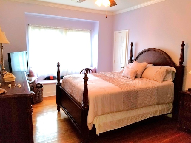 bedroom featuring ceiling fan, hardwood / wood-style flooring, and ornamental molding