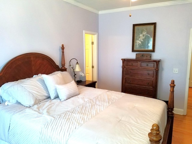 bedroom featuring crown molding and hardwood / wood-style flooring