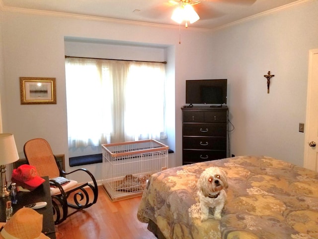 bedroom featuring crown molding and light hardwood / wood-style flooring