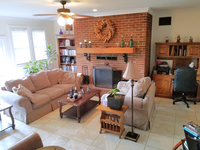 living room with crown molding, light tile patterned flooring, ceiling fan, and a fireplace