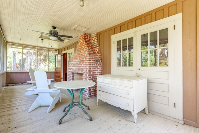 sunroom / solarium featuring ceiling fan and wooden ceiling