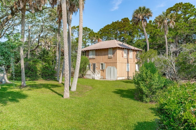 rear view of property with a lawn