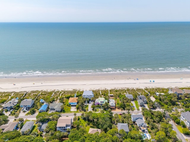 birds eye view of property featuring a beach view and a water view