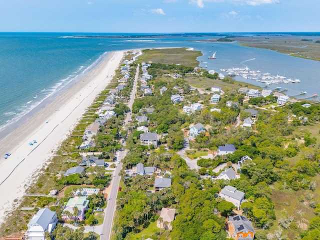 bird's eye view with a water view and a beach view