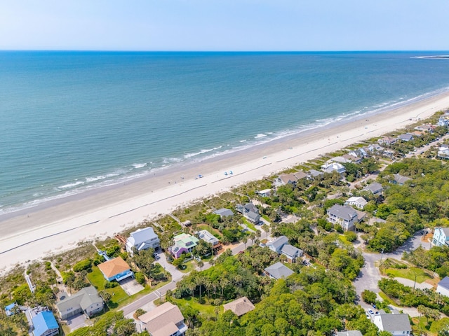 drone / aerial view with a water view and a beach view