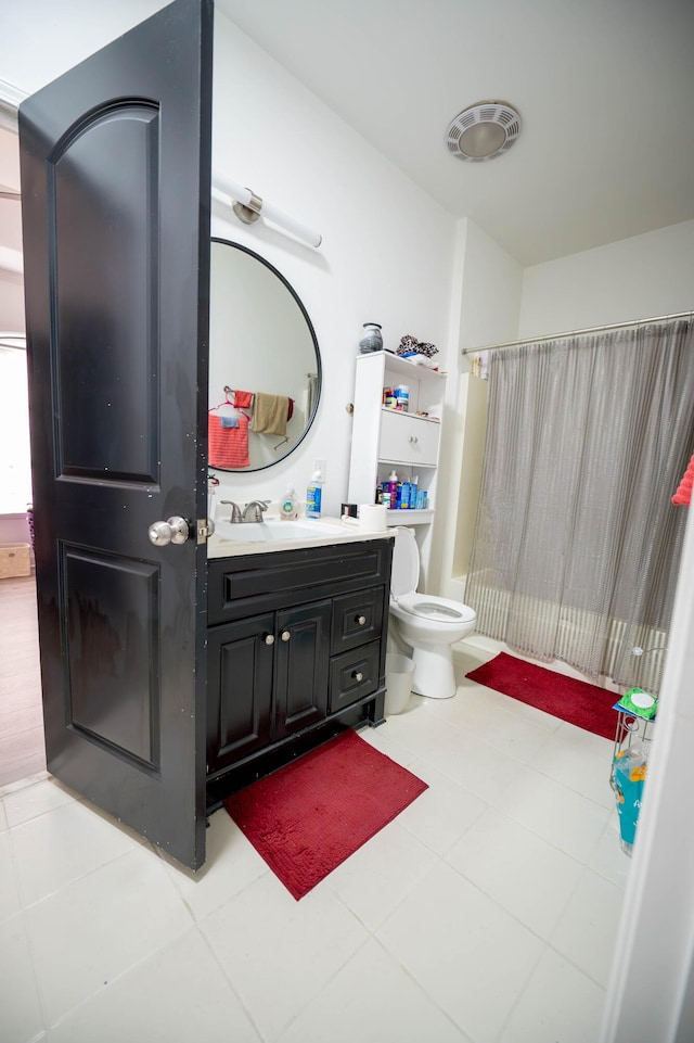 full bathroom with vanity, toilet, tile patterned flooring, and shower / bath combo