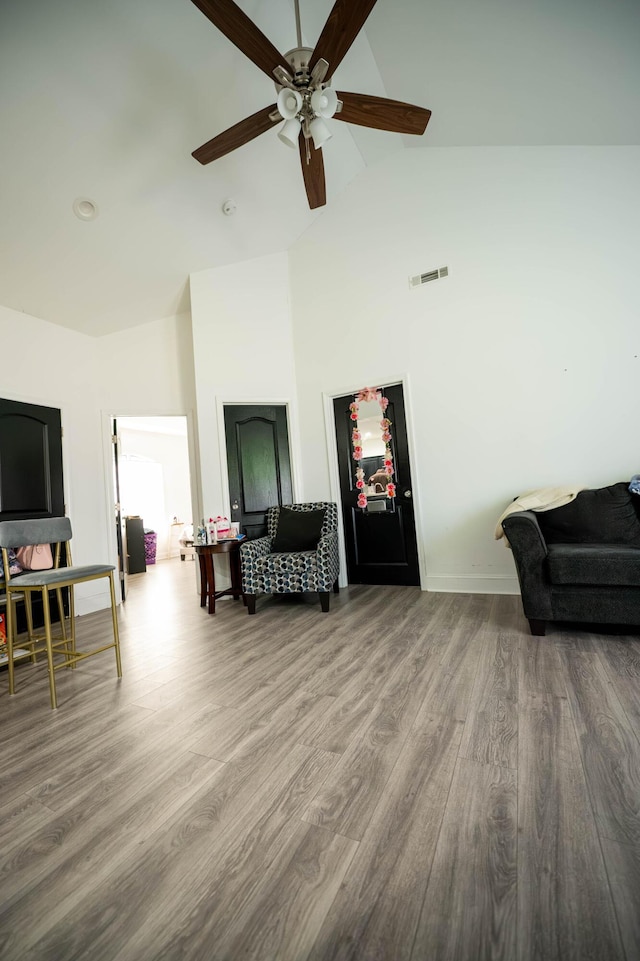 sitting room with ceiling fan, high vaulted ceiling, and hardwood / wood-style floors