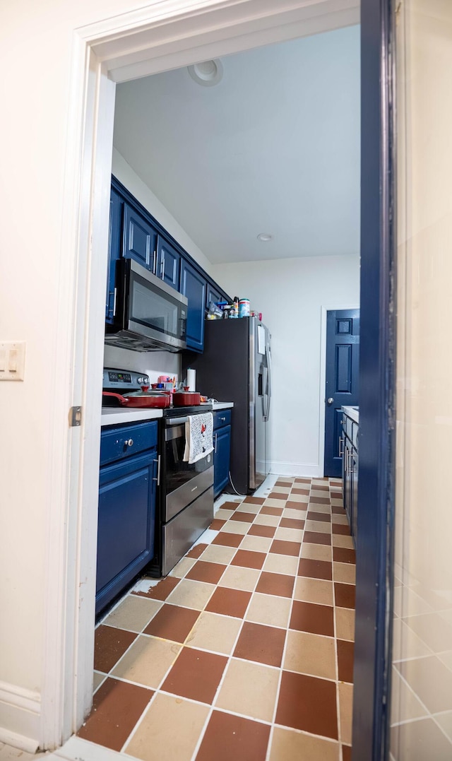 kitchen with blue cabinets and appliances with stainless steel finishes