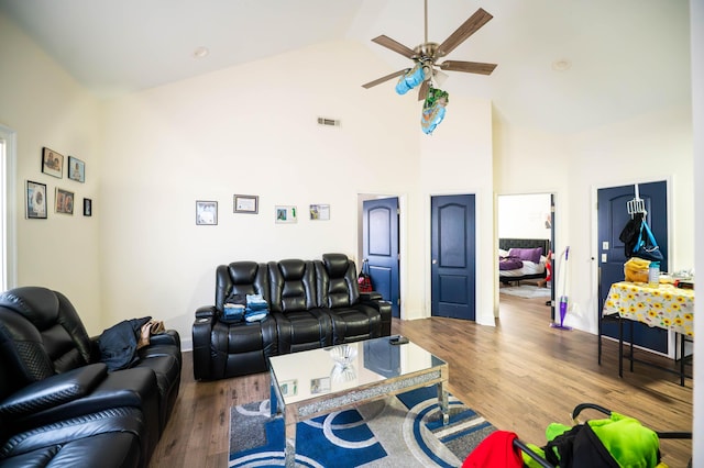 living room with hardwood / wood-style floors, high vaulted ceiling, and ceiling fan