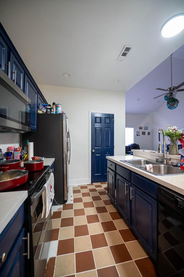 kitchen with appliances with stainless steel finishes, blue cabinets, sink, beverage cooler, and ceiling fan