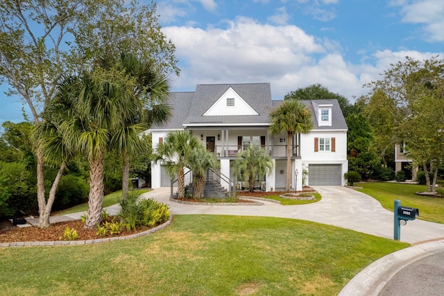 raised beach house featuring a garage, a front lawn, and a porch