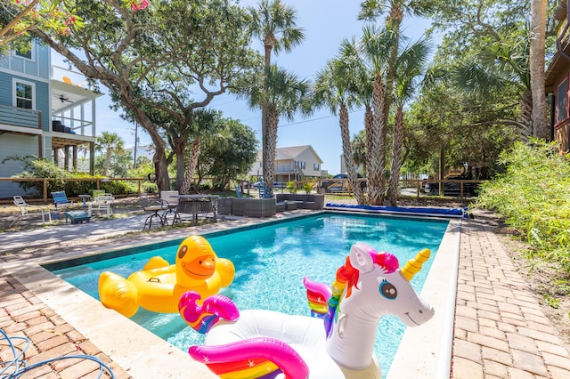 pool featuring an outdoor hangout area and a patio