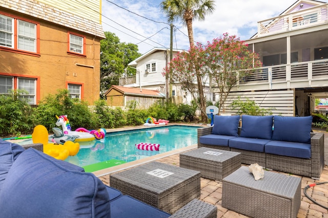 outdoor pool with an outdoor hangout area and a patio area