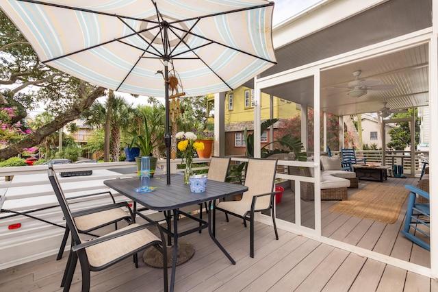 wooden deck featuring ceiling fan and outdoor dining area
