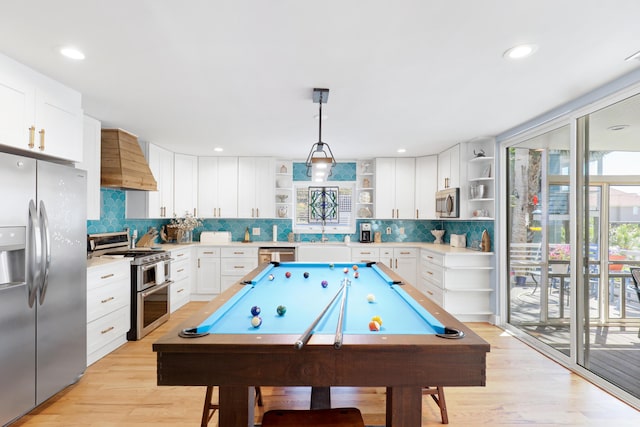 game room featuring recessed lighting, a sink, light wood finished floors, and pool table