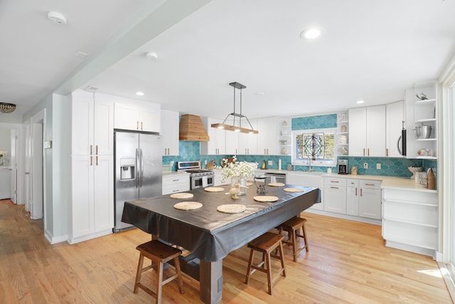 kitchen with open shelves, appliances with stainless steel finishes, white cabinets, and tasteful backsplash