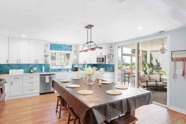 dining space with recessed lighting, light wood finished floors, and visible vents