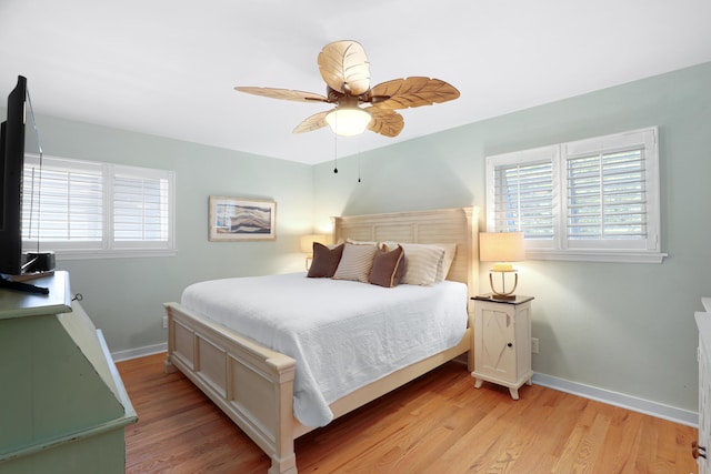 bedroom featuring baseboards, ceiling fan, and light wood-type flooring