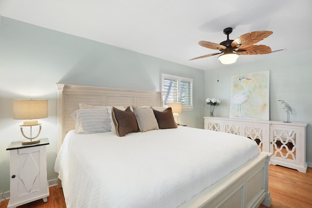 bedroom featuring ceiling fan, light wood-style flooring, and visible vents