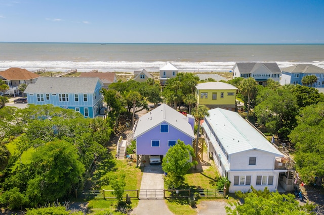 birds eye view of property featuring a water view and a beach view